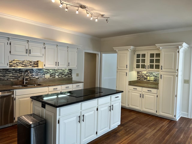 kitchen with sink, a kitchen island, stainless steel dishwasher, white cabinetry, and dark hardwood / wood-style flooring