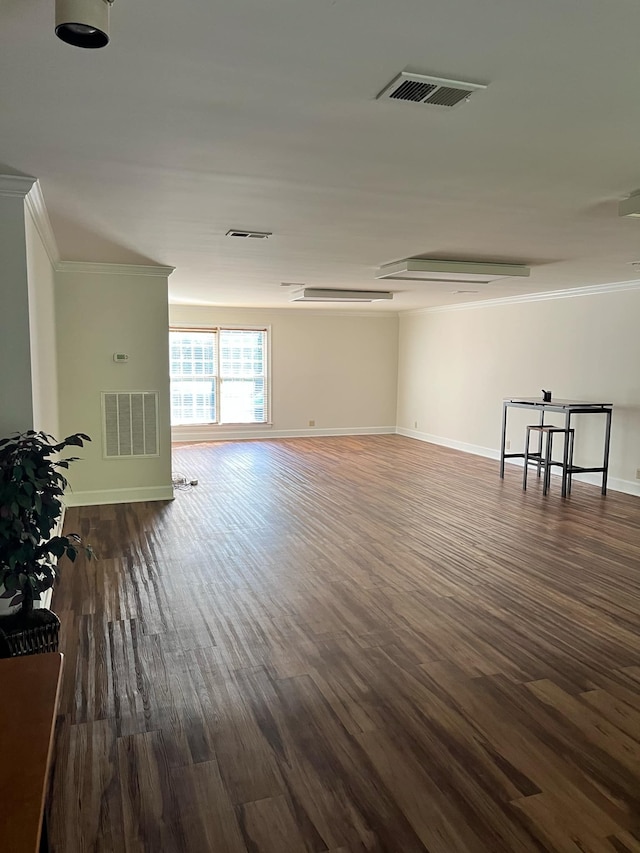 unfurnished living room with dark hardwood / wood-style floors and crown molding