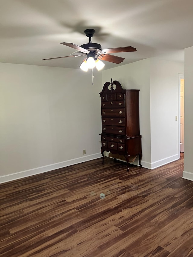 unfurnished bedroom featuring ceiling fan and dark hardwood / wood-style floors