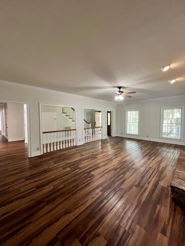 unfurnished living room with ceiling fan, ornamental molding, and dark hardwood / wood-style flooring