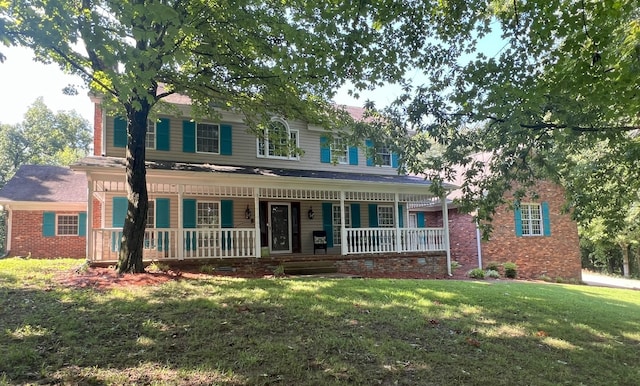 view of front of home with covered porch and a front yard