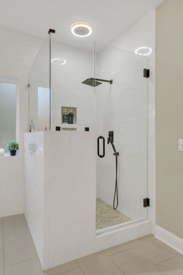 bathroom with walk in shower and tile patterned floors