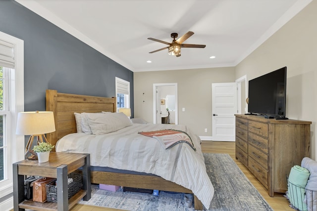 bedroom with crown molding, ensuite bathroom, light wood-type flooring, and ceiling fan