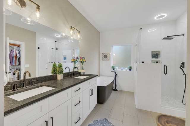 bathroom featuring separate shower and tub, tile patterned floors, and vanity