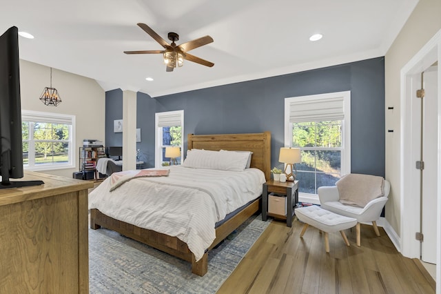 bedroom with ornamental molding, hardwood / wood-style flooring, and ceiling fan