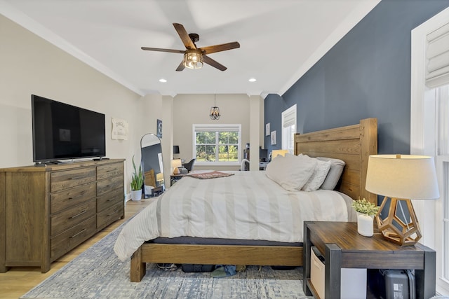 bedroom featuring crown molding, light wood-type flooring, and ceiling fan