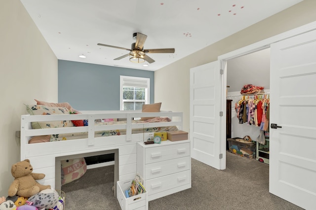 bedroom with ceiling fan, a closet, and dark carpet