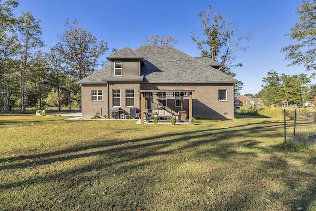 rear view of house featuring a yard and a deck