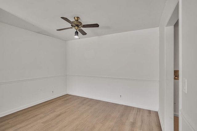 empty room with ceiling fan and light hardwood / wood-style flooring