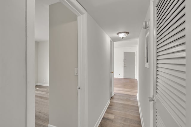 hallway with light hardwood / wood-style flooring