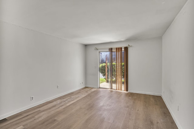 spare room with light hardwood / wood-style flooring