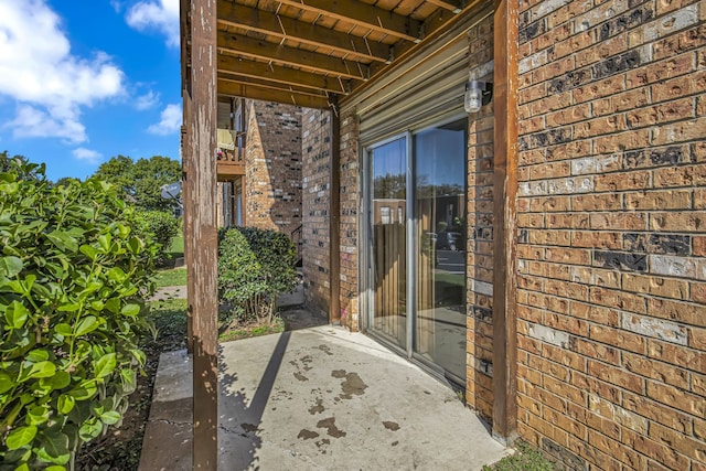 view of exterior entry featuring a patio