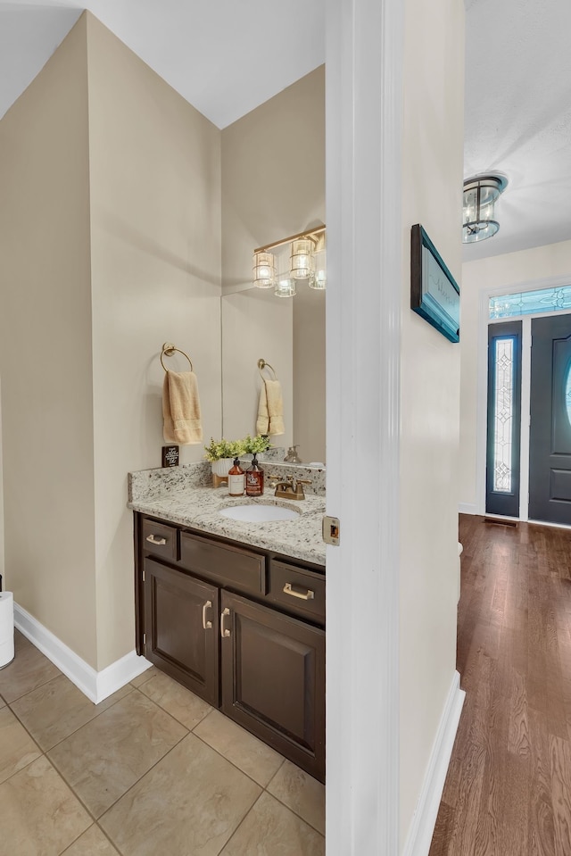 bathroom featuring hardwood / wood-style flooring and vanity