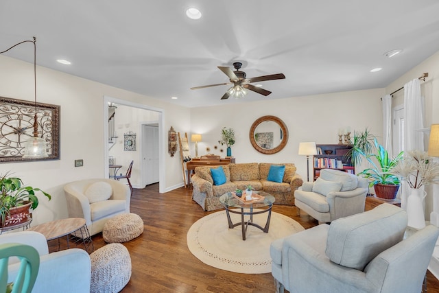 living room with ceiling fan and dark hardwood / wood-style flooring