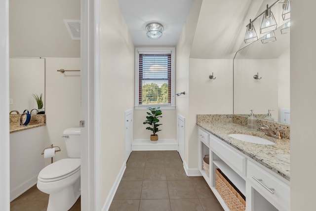 bathroom with vanity, tile patterned flooring, and toilet