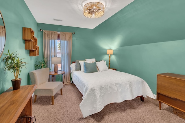 bedroom featuring light colored carpet and vaulted ceiling