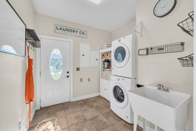 washroom featuring electric panel, sink, light tile patterned floors, and stacked washer and clothes dryer