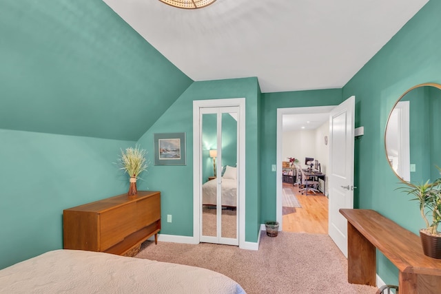 carpeted bedroom featuring lofted ceiling