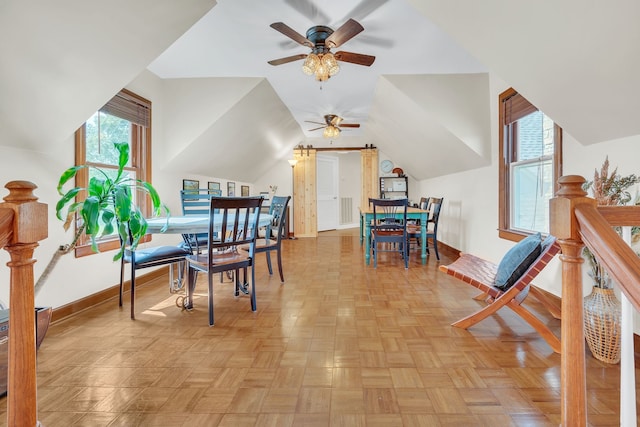 dining room with vaulted ceiling, ceiling fan, and light parquet flooring