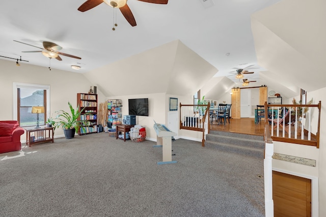 interior space with ceiling fan, lofted ceiling, and carpet flooring