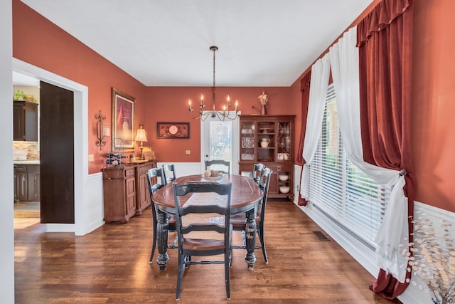 dining room featuring a notable chandelier and dark hardwood / wood-style floors