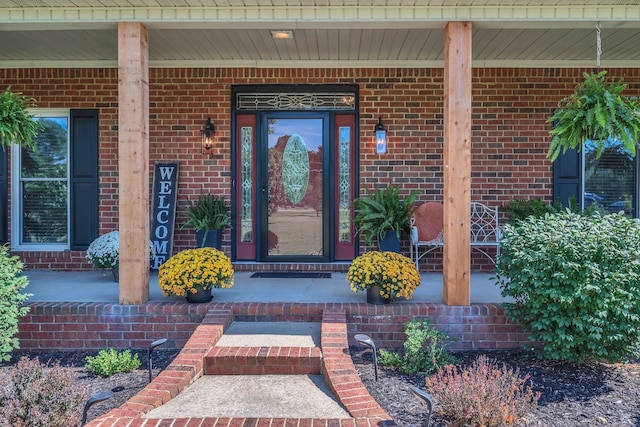 view of exterior entry featuring a porch