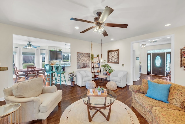 living room featuring dark hardwood / wood-style floors and ceiling fan