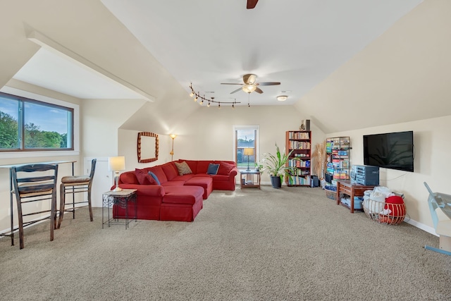 living room with ceiling fan, lofted ceiling, and carpet