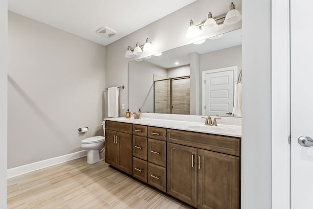 bathroom with hardwood / wood-style flooring, vanity, toilet, and a shower with door