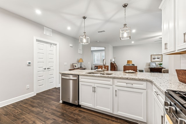 kitchen featuring white cabinets, hanging light fixtures, sink, dark wood-type flooring, and appliances with stainless steel finishes