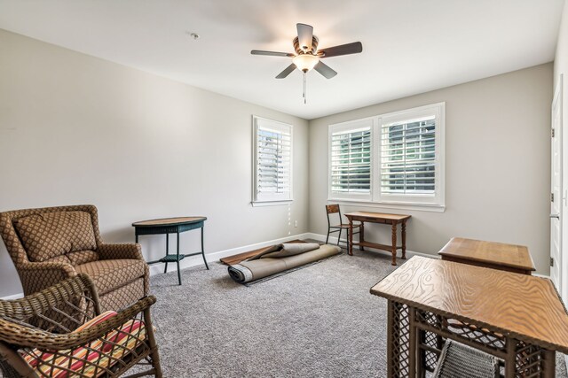 sitting room featuring ceiling fan and carpet