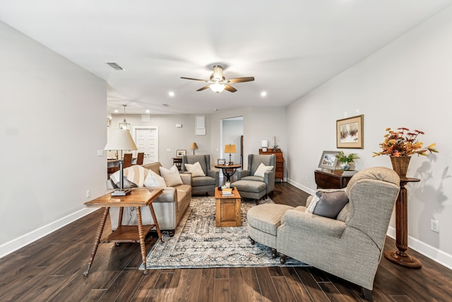 living room featuring ceiling fan and dark wood-type flooring