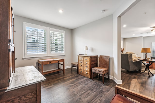 sitting room with ceiling fan and dark hardwood / wood-style flooring