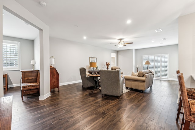 living room with ceiling fan, dark hardwood / wood-style floors, and plenty of natural light