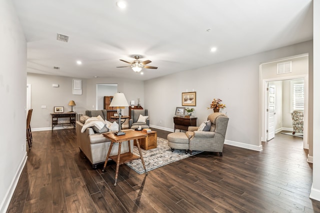 living room featuring dark hardwood / wood-style floors and ceiling fan