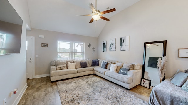 living room with ceiling fan, light hardwood / wood-style floors, and high vaulted ceiling