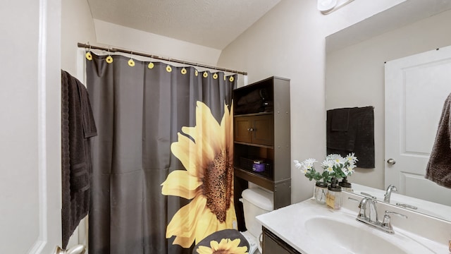 bathroom featuring a textured ceiling, vanity, toilet, and a shower with curtain