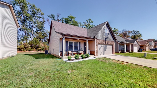 view of front of house with a front yard, central air condition unit, and a garage