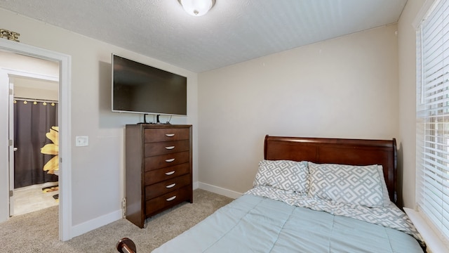 bedroom featuring light carpet and a textured ceiling