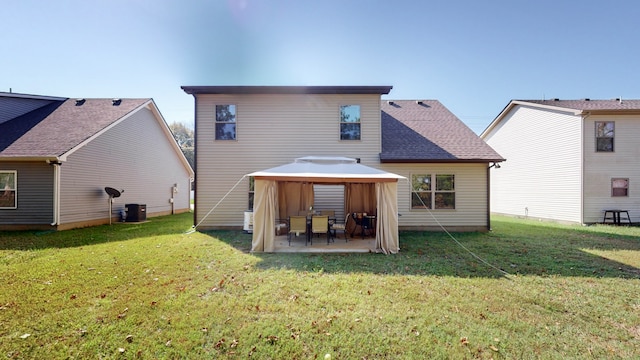 rear view of house with a lawn, a gazebo, and a patio area