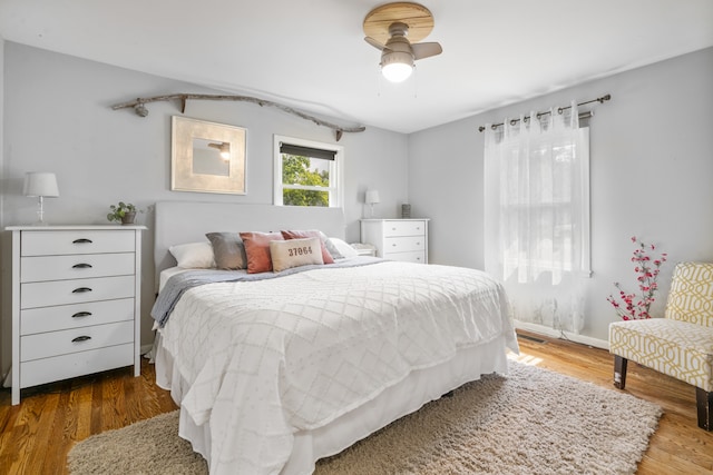 bedroom with ceiling fan and hardwood / wood-style flooring