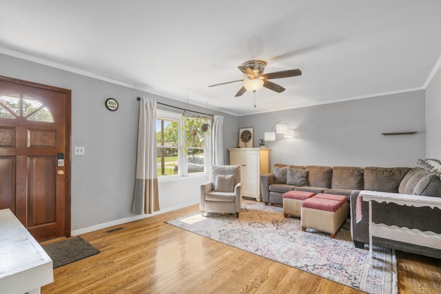 living room featuring ornamental molding, plenty of natural light, and light hardwood / wood-style floors