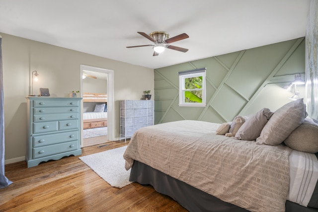 bedroom with ceiling fan and hardwood / wood-style floors