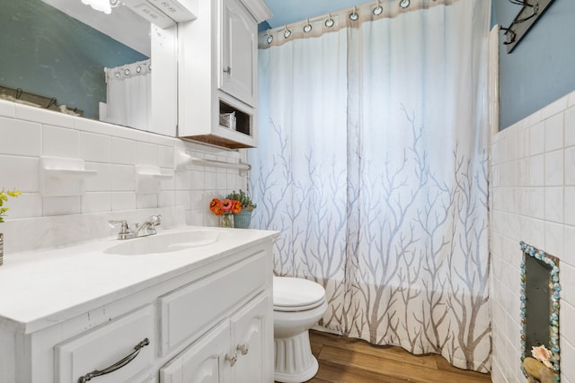 bathroom with vanity, wood-type flooring, tile walls, toilet, and a shower with shower curtain