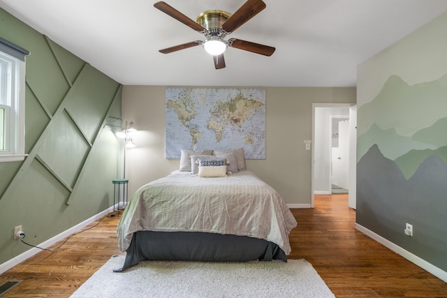 bedroom with ceiling fan and hardwood / wood-style floors