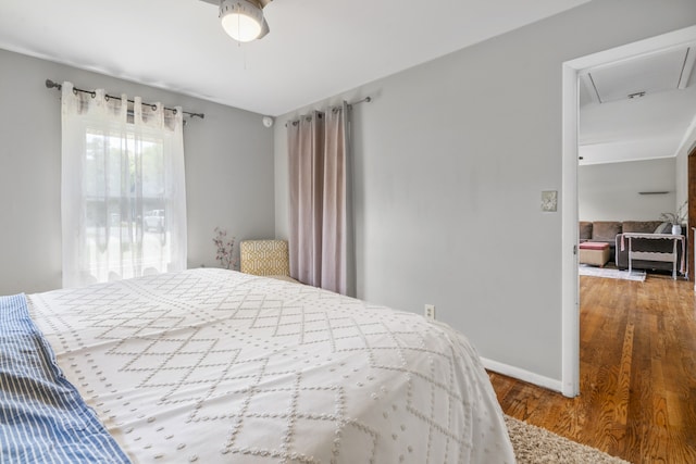 bedroom with ceiling fan and hardwood / wood-style floors