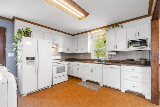 kitchen featuring white cabinets, sink, white appliances, light parquet flooring, and washer / clothes dryer