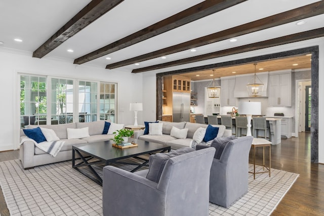 living room with beam ceiling, light wood-type flooring, and an inviting chandelier