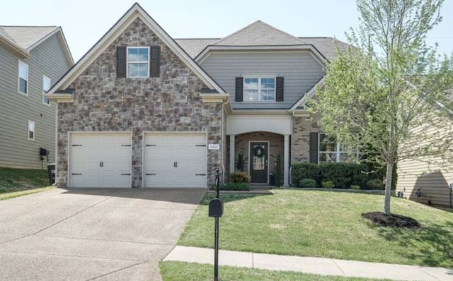 craftsman inspired home with a front yard and a garage