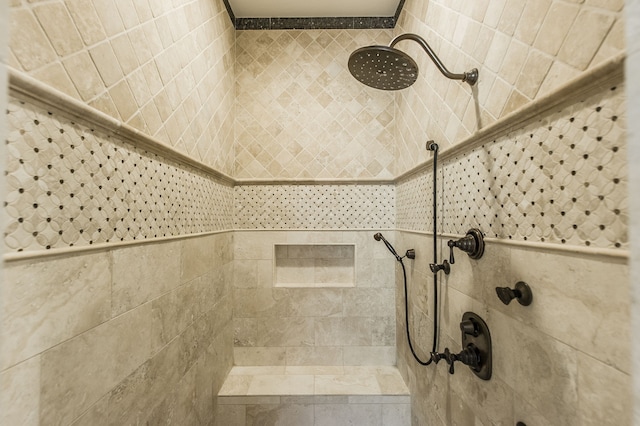 interior details featuring tiled shower